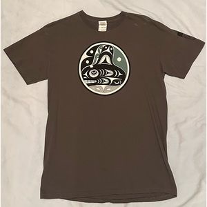 Men’s med army green Native Northwest design shirt from the Seattle Art Museum